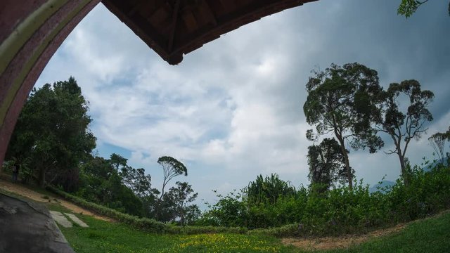 Timelapse of the sky with summer clouds and wooden building