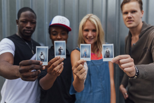 Group of Young People Showing their Picture . Individuality and Friendship concept