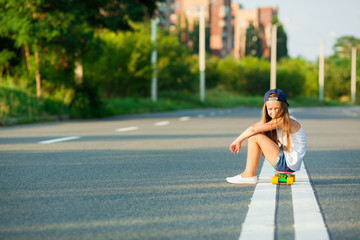 A young girl with penny board .
