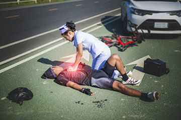 Female nurse helping Emergency CRP on bicycle man in an accident