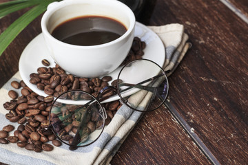 coffee cup and beans on the wood