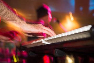 Musician plays keyboards in a rock band