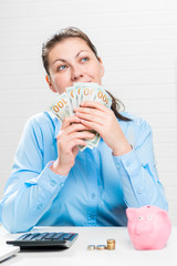 Happy pensive businesswoman with a fan of 100 dollar bills