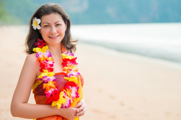 Horizontal portrait of a woman on the beach in floral Hawaiian Lei