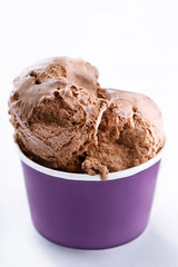 Ice cream cup on white background. Fresh organic chocolate handmade ice cream in a purple paper cup.