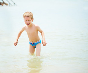 Cheerful boy in the water of the black sea
