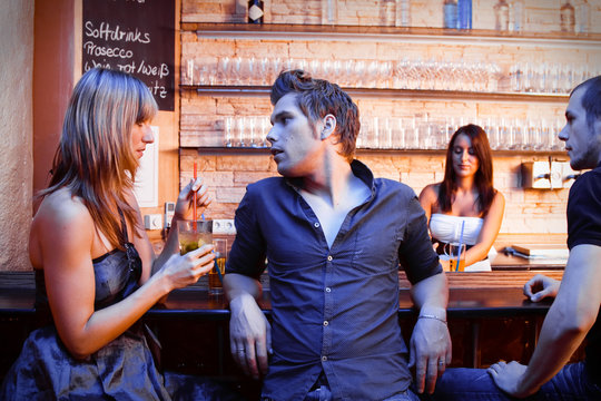 Young People Flirting At The Bar
