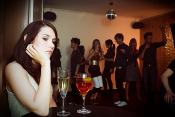 Fototapeta Young Woman Is Sitting Alone In A Nightclub obraz