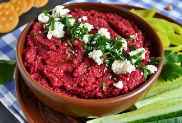 Appetizer of chickpeas - hummus with beetroot, vegetables and feta