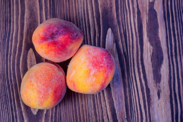 Fototapeta na wymiar Juicy peaches on wooden background