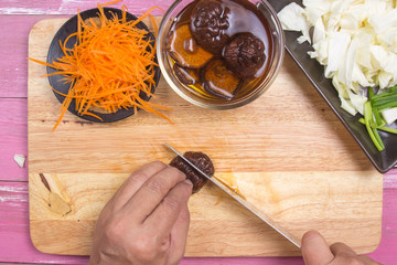 Chef slicing mushroom for cooking