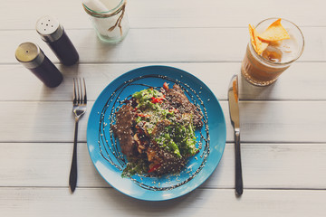 Restaurant food, warm meat salad top view