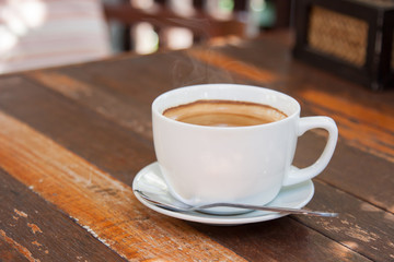 Hot espresso coffee on wooden table