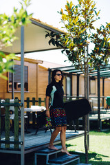 Woman with surfing board walking 