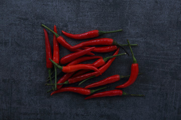 Chili pepper on dark rock background