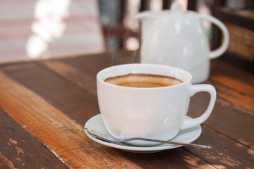 Hot espresso coffee on wooden table