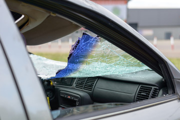 Damaged car with broken windshield