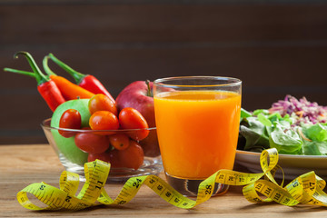 Healthy concept with mixed fruits and vegetables on wooden background