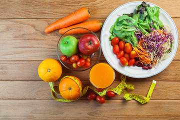 Healthy concept with mixed fruits and vegetables on wooden background
