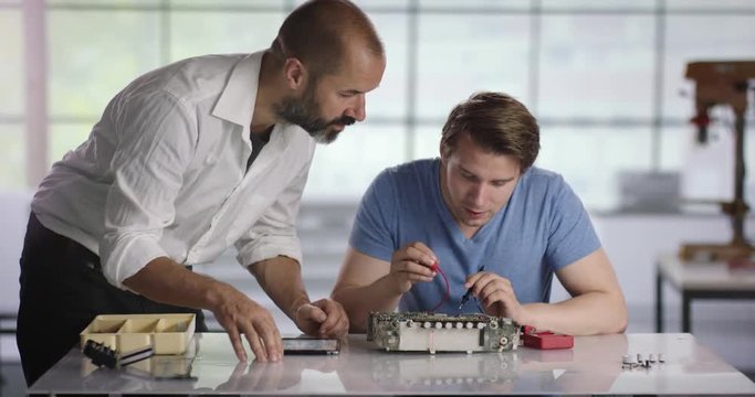 Electrican trainee getting help from his trainer