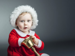 adorable 2 year old caucasian baby girl with santa claus dress, studio shot.