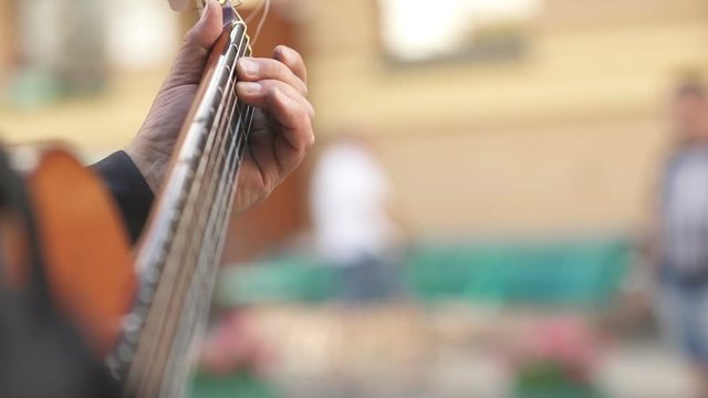 Guitarist hits the strings of the guitar