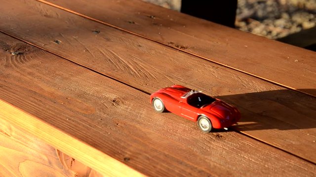 Toy car travels on a bench