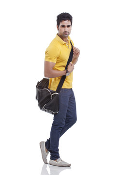 Portrait Of Handsome Young Man With Duffel Bag 