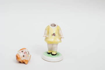 Broken porcelain doll figurine - little girl lost his head