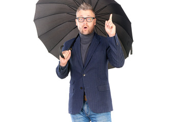 Portrait of elegant middle-aged man holding open black umbrella