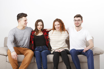 Happy young friends, casual people sitting on couch