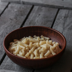 Pasta with butter in a glaze bowl