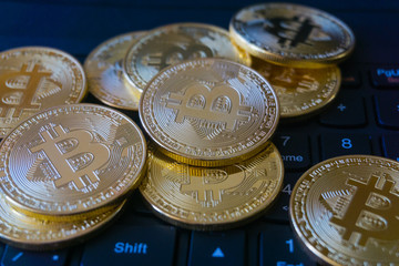 Golden Bitcoins on a laptop keyboard. Cryptocurrency