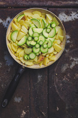Potatoes and zucchini roasted in a frying pan