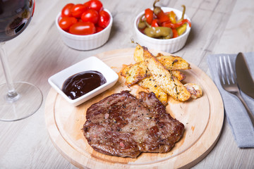 Marble beef with potatoes, tomatoes and pepperoni. Selective focus.
