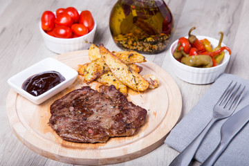 Marble beef with potatoes, tomatoes and pepperoni. Selective focus.