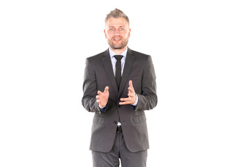 Portrait of middle-aged businessman in elegant suit posing against white background