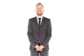 Portrait of middle-aged businessman in elegant suit posing against white background
