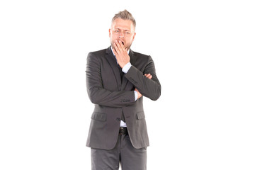Portrait of middle-aged businessman in elegant suit posing against white background