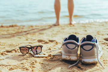 sunglasses with snickers on the beach, man stands on background