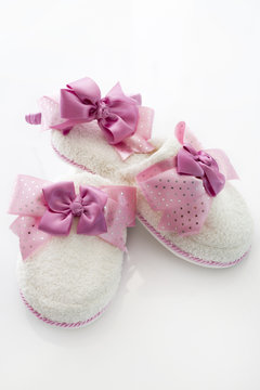 Pair of blank white home slippers and ornate coronet. Bed shoes accessory footwear