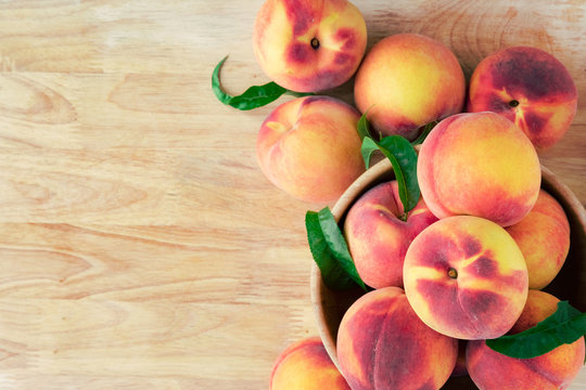 Peaches on wooden background with copy space