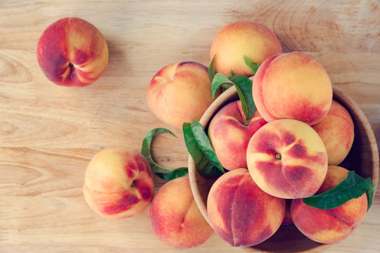 Peaches on wooden background