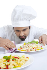 Chef cleaning side of plate
