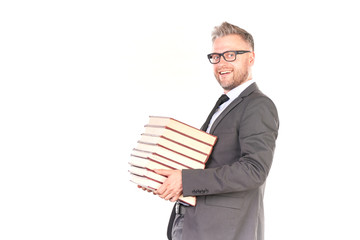 Portrait of middle-aged man in suit holding heap of books
