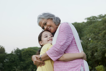 Grandmother and granddaughter hugging