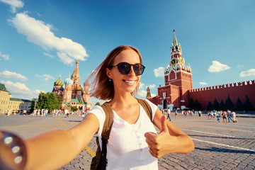 Travel and technology. Happy young woman taking selfie on Red Square in Moscow, Russia.