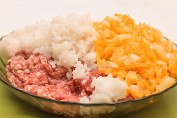 Homemade stuffed peppers with minced meat, carrots, onions, rice. Cooking process. Mixing stage of products