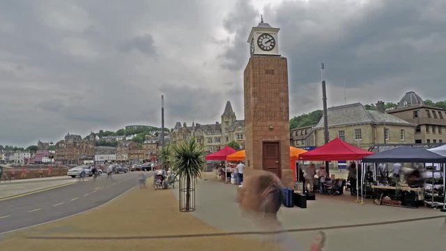 Time lapse of people moving around the Oban clock