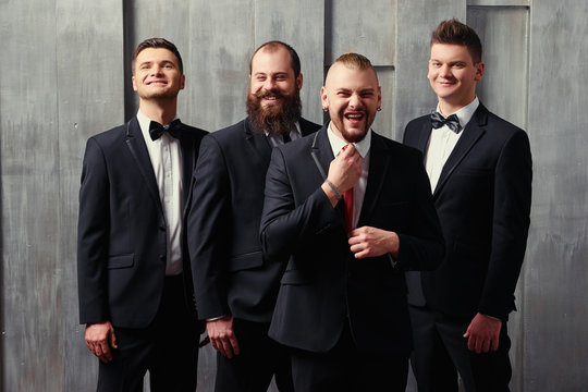 Group of handsome elegant young men in tuxedo.